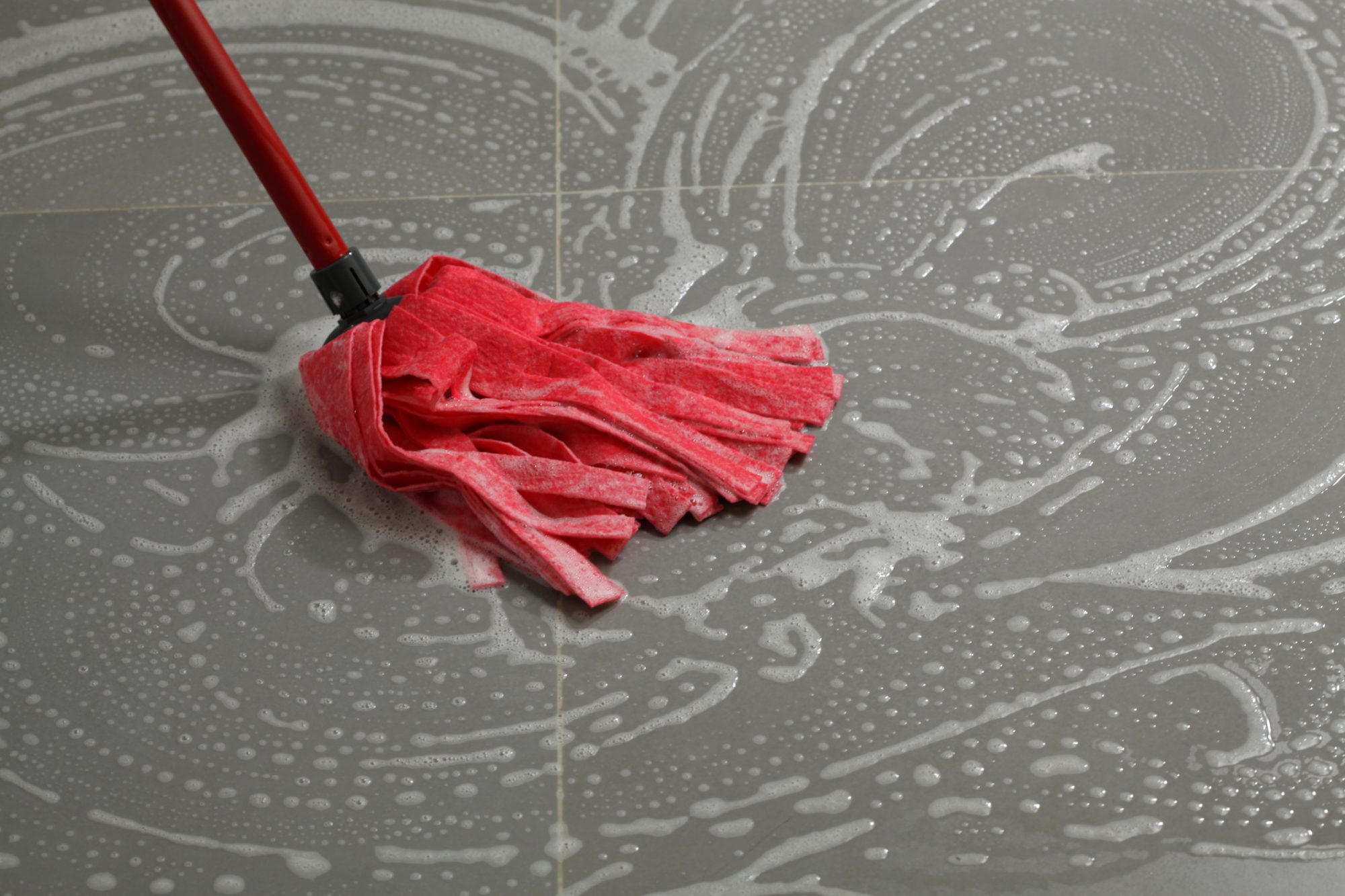 Cleaning the floor tiles with mop,housework in kitchen