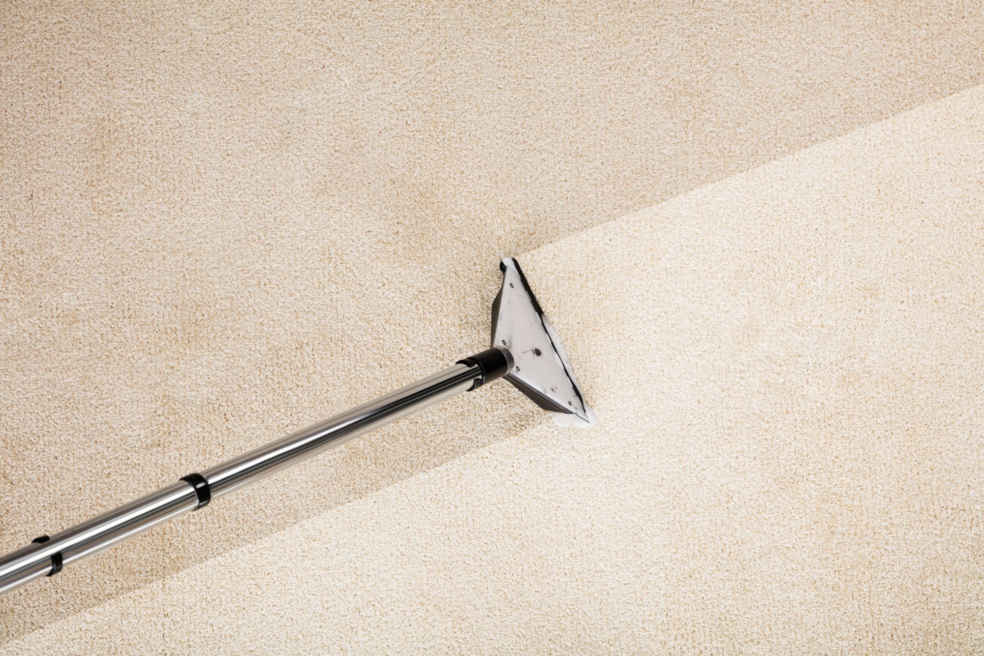 Close-up Photo Of Vacuum Cleaner With Carpet